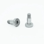 When an assembly fails due to an improper fastener, the cost is no longer just replacing a component. Time is lost, work needs to be redone, and in some cases, a component can be scrapped, which could have taken hours to machine. Anyone who works in a high-tolerance environment understands this feeling. One bad decision in the fastener selection process can cause a project to be stalled for days. Shoulder screws do not always get the attention they deserve in that conversation. They should. Here is why they matter more than most people think. What Makes a Shoulder Screw Different A shoulder screw has three distinct sections: a head, a smooth cylindrical shoulder, and a threaded end. The shoulder is the key part. It is precision-ground to a tight dimensional tolerance, usually within 0.001 inches or better. That smooth, unthreaded section is what separates it from a standard fastener. Standard screws grip by threading into a material. Shoulder screws work differently. The shoulder acts as a bearing surface, a pivot point, or a precise spacer. The threaded portion only anchors it in place. The shoulder does the actual mechanical work. This distinction matters a lot in assemblies where movement, alignment, or spacing needs to be exact. Where Shoulder Screws Get Used The list of applications is longer than most people expect. Pivot points in jigs and fixtures Linear guides and slide mechanisms Cam followers and linkage assemblies Precision spacing in multi-layer assemblies Hinges in aerospace and defence components Robotic arm joints and actuator mounts What connects these applications is the need for controlled movement or precise positioning. A shoulder screw does not just hold things together. It defines how those things relate to each other spatially. In a jig or fixture, even a 0.01mm shift in a pivot point can throw off the entire operation. A shoulder screw, properly specified, keeps that shift from happening. The Real Risk of Getting It Wrong A lot of engineers substitute a standard bolt with a washer when they need a shoulder screw function. It works, sometimes. But it rarely works consistently. The problem is tolerance stacking. A bolt and washer combination introduces multiple surfaces, each with its own dimensional variation. Over time, and under load, those variations add up. What starts as a minor slip becomes a measurable error. In precision assemblies, that error is the difference between a part that passes inspection and one that does not. There is also wear to think about. A smooth, hardened shoulder resists wear far better than the body of a standard bolt. In pivot applications, this matters. A worn pivot changes the geometry of the assembly. That changes the output. And in industries such as aerospace or medical device assembly, changes in output are not acceptable. The fear is legitimate. Design something precise, specify the wrong fastener, and your tolerances will be gone in a few thousand cycles. Material and Hardness Matter Shoulder screws have several materials from which they're manufactured: Stainless Steel, Alloy Steel, and, in weight-constrained systems, Titanium. Material selection is significant for both performance and environmental considerations. Alloy Steel shoulder screws, designed to either ASTM or DIN specifications, have high tensile strengths. They're good for high-load pivot applications where the shoulder is subject to significant stress. Stainless Steel is good in corrosive environments, but is generally not as hard. That is significant if your assembly is in a wet or chemically active environment. The shoulder hardness is perhaps the most overlooked spec. A harder shoulder resists galling and wear in rotating or oscillating contact. Rockwell C hardness ratings for alloy steel shoulder screws typically range from 38 to 43 HRC, according to manufacturer data from Holo-Krome. If there are repeated movements, shoulder hardness is not optional information. It defines service life. Fit Tolerance and Why It Changes Everything Shoulder screw fit, or the relationship of the screw to the hole it fits into, is where precision either occurs or does not. There are three types of fit that are of concern: Clearance fit: The hole is somewhat larger than the shoulder screw. It allows for free rotation or sliding motion. Transition fit: Slight clearance or interference. It is used for alignment, but motion is necessary. Interference fit: The shoulder is larger than the hole. Used for fixed, non-moving applications. For most pivot and sliding applications, a clearance fit with tight tolerances, typically H7/h6 in ISO terms, gives the right balance of free movement and positional accuracy. The ISO 286 standard outlines these fit classifications in detail. Getting the fit wrong usually means one of two things: too much slop causes positional error, or too much interference creates binding and accelerated wear. To Conclude Shoulder screws are not complex fasteners. The complexity is in matching them correctly to what the application actually demands. Get that part right, and they will hold up for a long time.