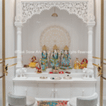 Home interiors shift with every passing season. Colour palettes change, furniture styles evolve, and what felt contemporary five years ago can look dated today. Yet some pooja rooms seem to exist outside this cycle entirely. They age without looking old. The reason, more often than not, comes down to how they were built and what they were built with. When a space is designed around material quality rather than momentary trends, the result holds up differently over time. A luxury marble pooja room carries an inherent permanence that trend-led décor cannot replicate. The stone tells a story that does not go out of fashion. Its natural veining, quiet weight, and subdued authority create a spiritual atmosphere that feels as relevant a decade from now as it does today. When Material Becomes the Design The Problem With Trend-Led Spaces: Many homeowners invest heavily in décor that photographs beautifully but ages poorly. A pooja room built around a particular colour trend or popular finish will eventually demand updating. That cycle is costly, and perhaps more importantly, it chips away at the sanctity a prayer space deserves. The atmosphere of a sacred corner should not depend on what is in fashion that year. Why Stone Outlasts Style: Natural marble carries its own visual identity, quite independent of design fashions. The variation within each slab, the subtle shifts in tone, and the texture that changes with light are qualities no engineered surface fully replicates. A space built around genuine stone stops being a design statement and starts being something deeper. That is a distinction that matters more than most people initially realise. What Marble Actually Brings to a Sacred Space Durability That Reads as Permanence: Marble's crystalline structure gives it a density and longevity that softer materials cannot match. A well-maintained marble surface resists the kind of wear that visibly degrades most interiors over time. This is not only about aesthetics. It is about creating a space that looks as considered in twenty years as it does on installation day. That quality is worth planning for from the outset. The Spiritual Weight of Natural Stone: There is something about genuine marble that synthetic materials have never fully captured. The coolness of the surface, the way light settles differently across carved stone, the sense that the material carries real age and intention. These qualities contribute to an atmosphere of devotion that goes beyond visual appeal. A space built in natural stone feels different to stand in, and in a sacred context, that matters. Craftsmanship as the Third Dimension: Beyond the material itself, the quality of workmanship determines how a stone surface ages. A poorly finished marble surface will show its limitations within years. Skilled carving, proper surface finishing, and precise joinery create a result that looks considered rather than constructed. The difference between average and expert work becomes clearer over time, not less so. That is the craftsmanship argument. Elements That Carry a Room Across Decades The Enduring Power of Hand Carving: Carved floral motifs reference classical temple architecture, grounding a space in cultural continuity rather than passing trends. Geometric inlay work in contrasting marble tones creates visual rhythm that remains pleasing regardless of surrounding décor changes. Pillar detailing and arched niches introduce proportion and depth that the eye finds naturally satisfying over long periods. Fine relief carving on temple panels reflects light differently as the day progresses, keeping the space visually alive without any alterations to the room. Marble Inlay and the Language of Pattern: The technique of setting contrasting stone pieces into a base surface, a practice with centuries of history in Indian temple architecture, produces patterns that read as artful rather than decorative. Unlike applied finishes or surface prints, inlays are permanent. They become more appreciated as the room ages, not less. That quality is genuinely rare in any interior material. Balance Over Ornamentation: The longest-lasting pooja rooms are not necessarily the most elaborate. What makes a space endure is balance. The proportion of carving to a plain surface, the scale of the temple relative to the room, and the way sacred geometry informs the overall layout are the decisions that separate a space which ages gracefully from one that starts to feel heavy or overwrought over time. Spiritual Relevance Does Not Expire A Space That Grows With the Family: A well-designed marble pooja room tends to feel more significant over time, not less. As rituals accumulate and the space becomes part of daily life, its physical quality begins to matter in ways that are difficult to articulate but easy to feel. A space that holds up structurally and aesthetically becomes a site of genuine continuity, and that quality cannot be purchased with trend-led choices. The Cost of Getting It Wrong: Choosing cheaper materials for a pooja room may feel like a reasonable short-term decision. Over years, the discolouration, surface wear, and general deterioration begin to undermine the atmosphere entirely. A space that looked clean on your installation day can feel shabby within a few years. The investment in quality stone protects the spiritual character of the room across years of daily use. Stone That Still Speaks, Years From Now A pooja room built with genuine intent and quality materials rarely needs to be reconsidered. It simply continues to serve its purpose. If you are planning a sacred space and want it to carry that kind of longevity, connect with a specialist who understands both the material and the design principles that make marble pooja rooms last, not just for years, but across generations.